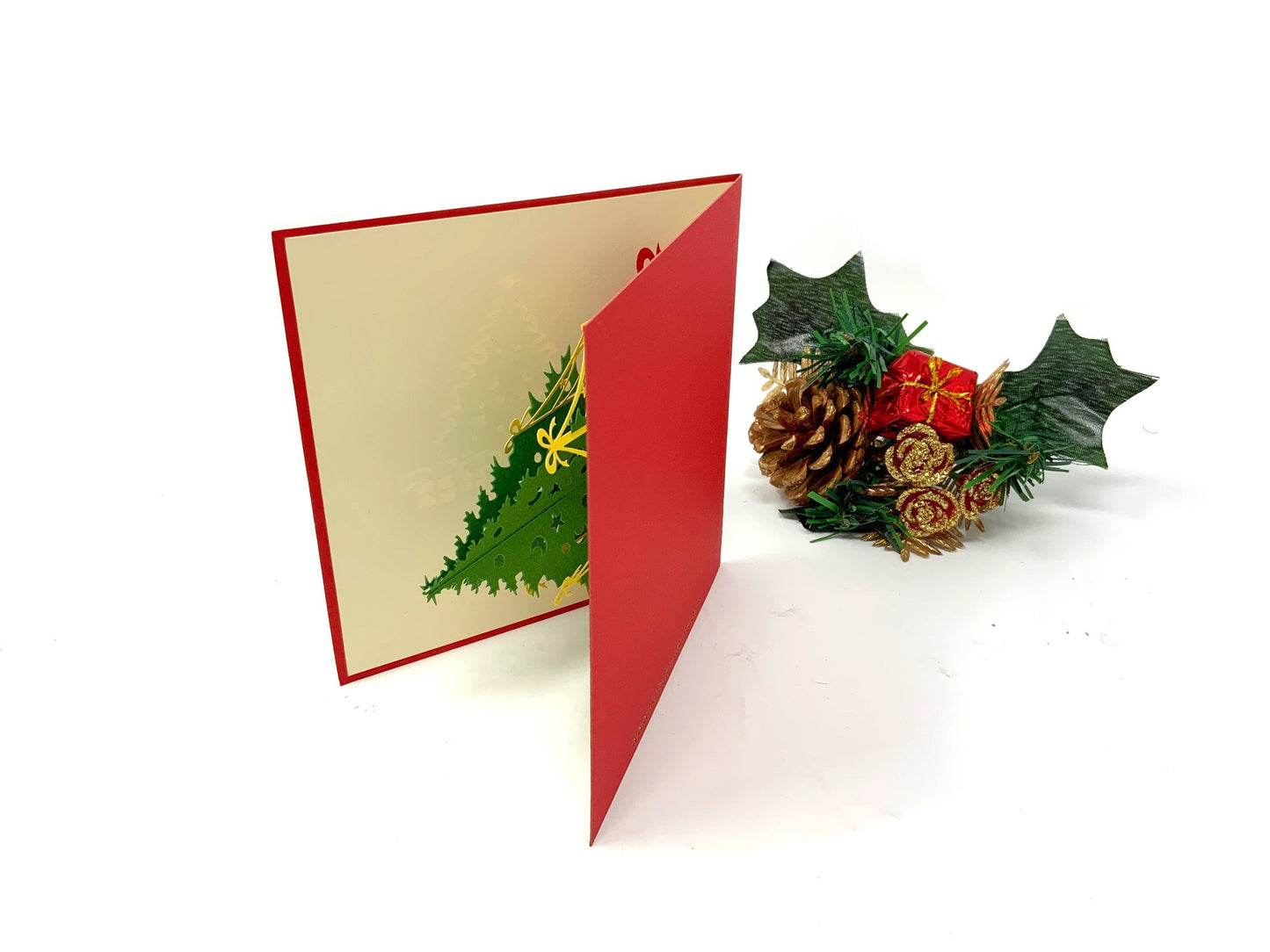"A 4-pack of mini Christmas tree pop-up cards: A collection of four small three-dimensional cards, each featuring an intricately crafted pop-up of a Christmas tree, perfect for celebrating the holiday season in a compact size."
