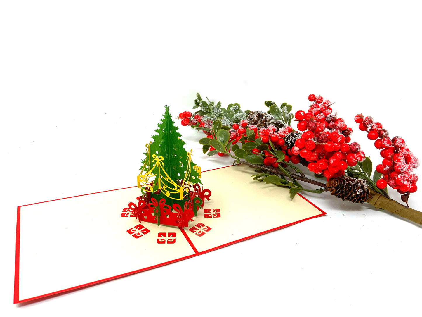"A 4-pack of mini Christmas tree pop-up cards: A collection of four small three-dimensional cards, each featuring an intricately crafted pop-up of a Christmas tree, perfect for celebrating the holiday season in a compact size."