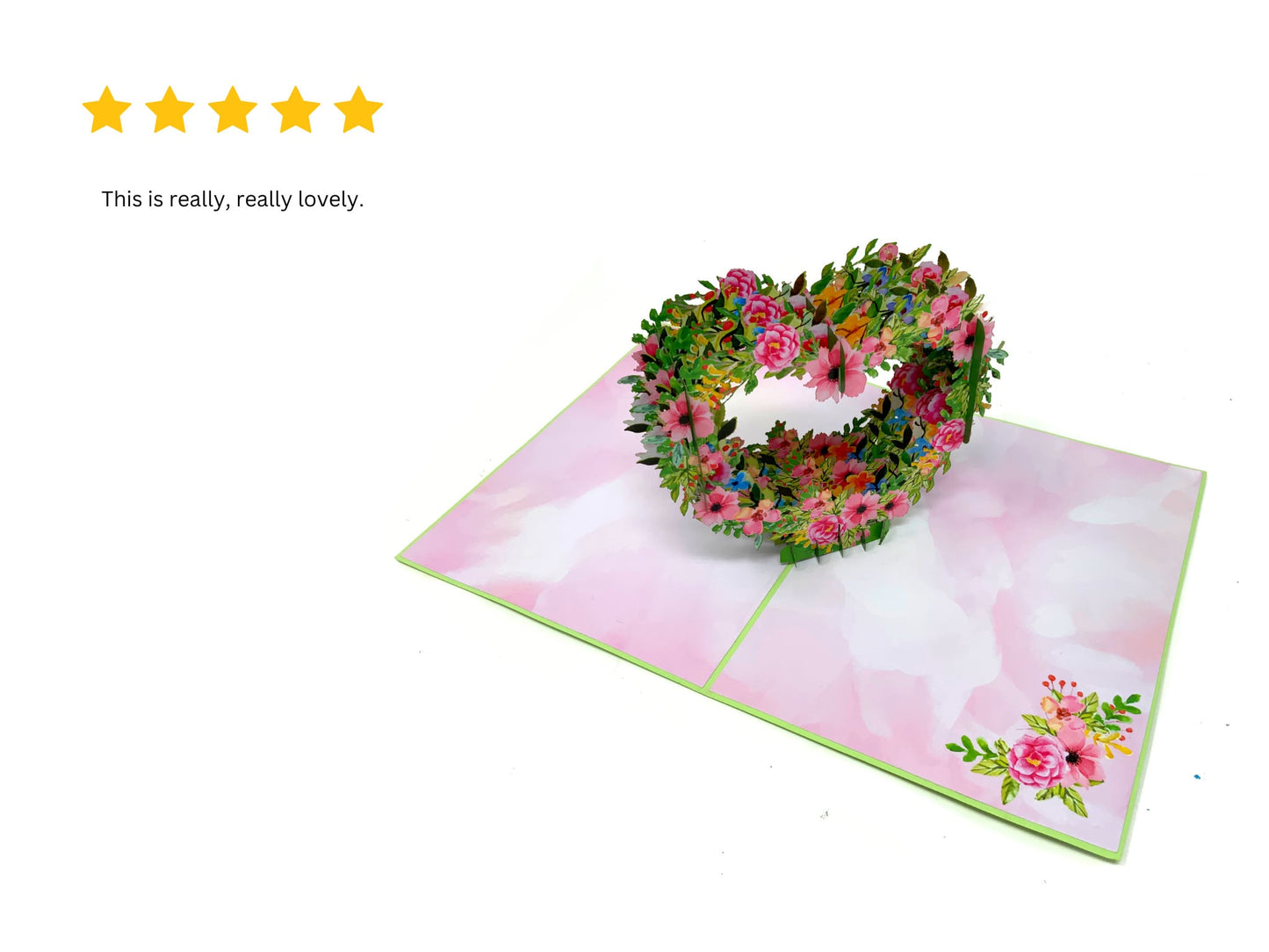 &quot;Floral heart pop-up card with a 5-star review: An image of the intricately designed heart-shaped pop-up card adorned with vibrant floral decorations, alongside a 5-star rating indicating high customer satisfaction.&quot;