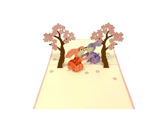 &quot;Rabbits in Love pop-up card: A three-dimensional card with an intricately crafted pop-up scene featuring adorable rabbits in love, perfect for expressing affection and warmth on various occasions.&quot;